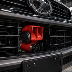 Close-up of durable red metal housing dual tone electrical horn with heavy duty construction for long lasting use